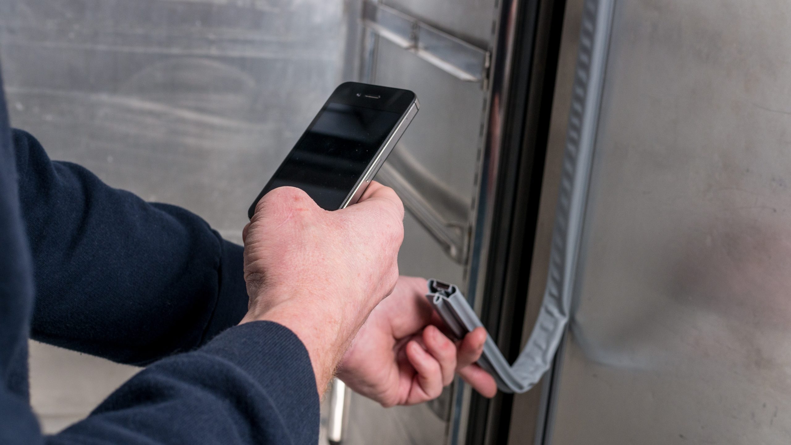Man inspecting fridge seals