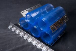 A photo of rolled up PVC strips and a mount, sold as a kit