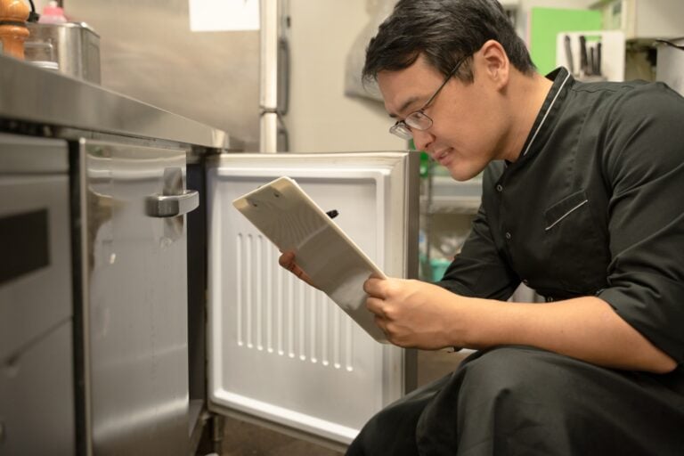 Male kitchen staff checking inventory
