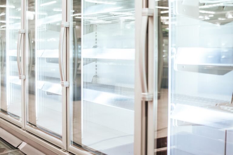 Empty refrigerator or freezer for food and grocery items in store. Selective focus.